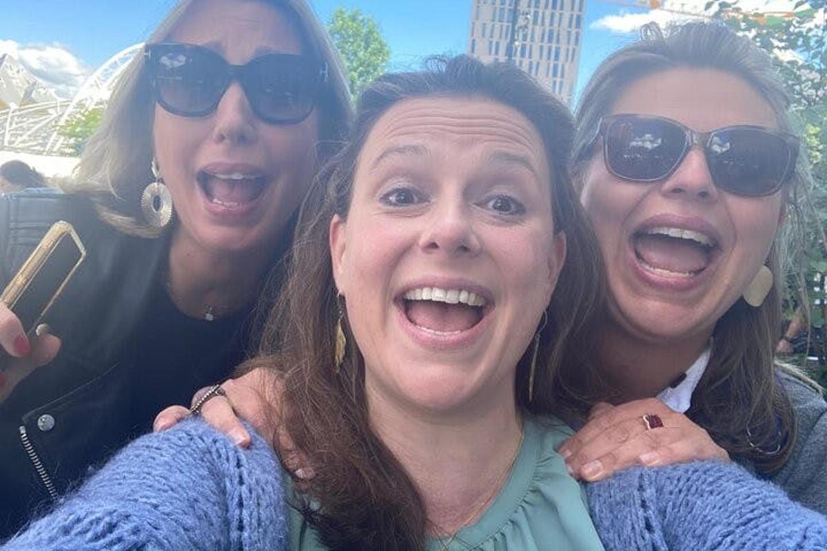 a group of three women posing for a picture