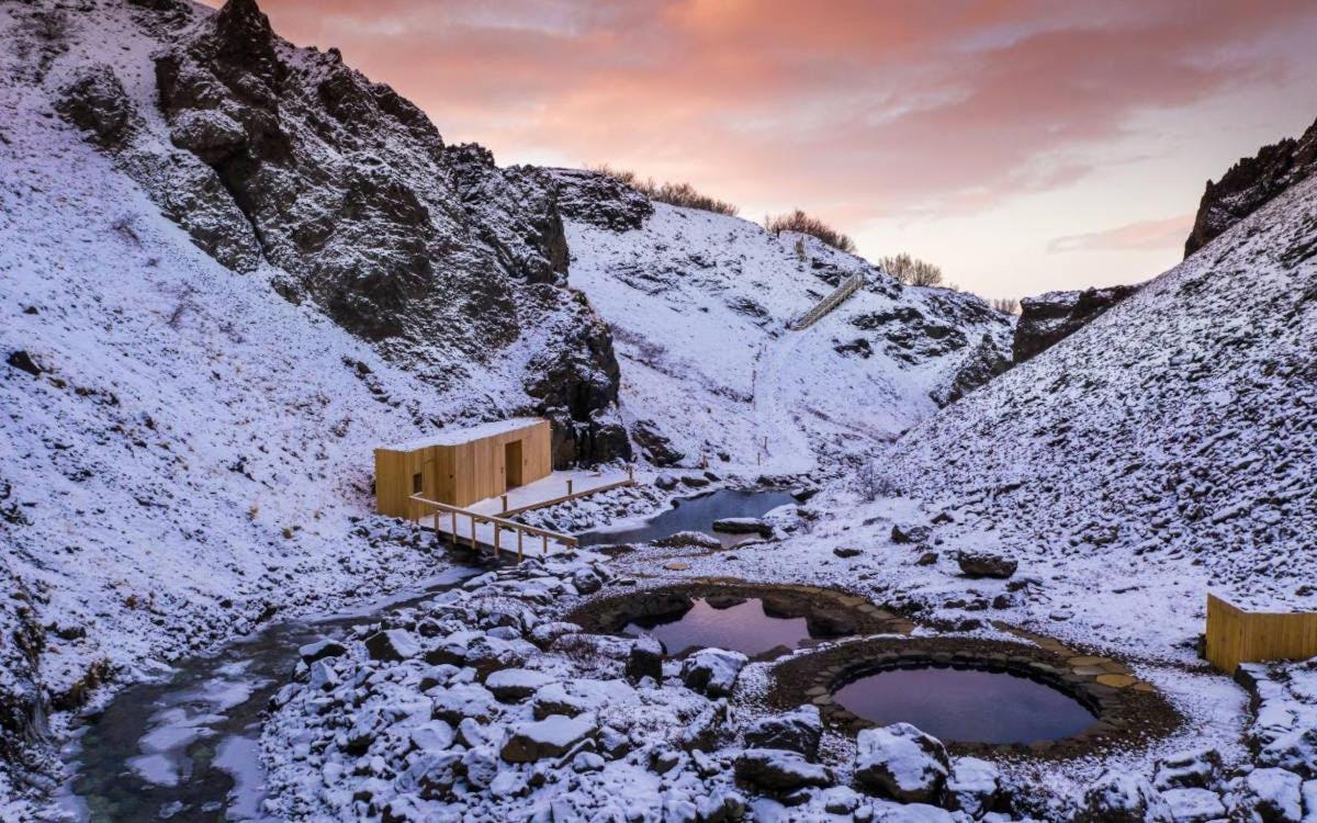 a snow covered mountain with two ponds in it