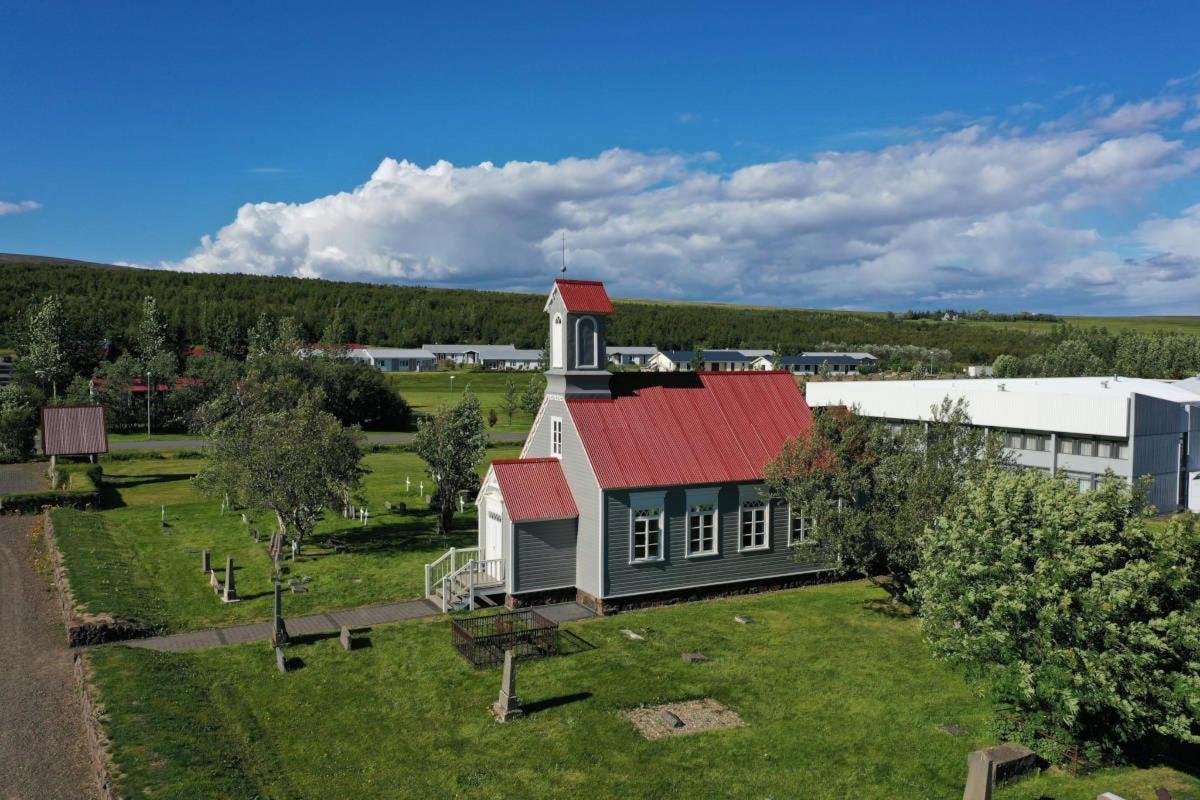 an aerial view of a house with a red roof