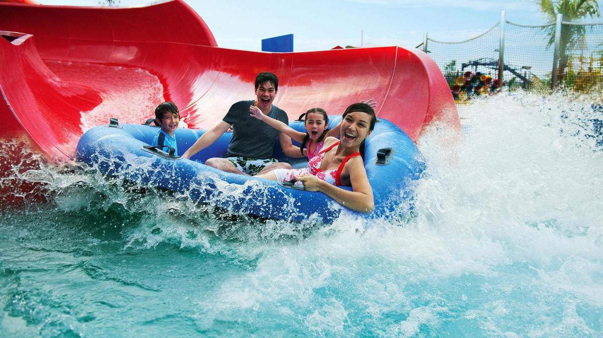 a group of people riding on a water slide