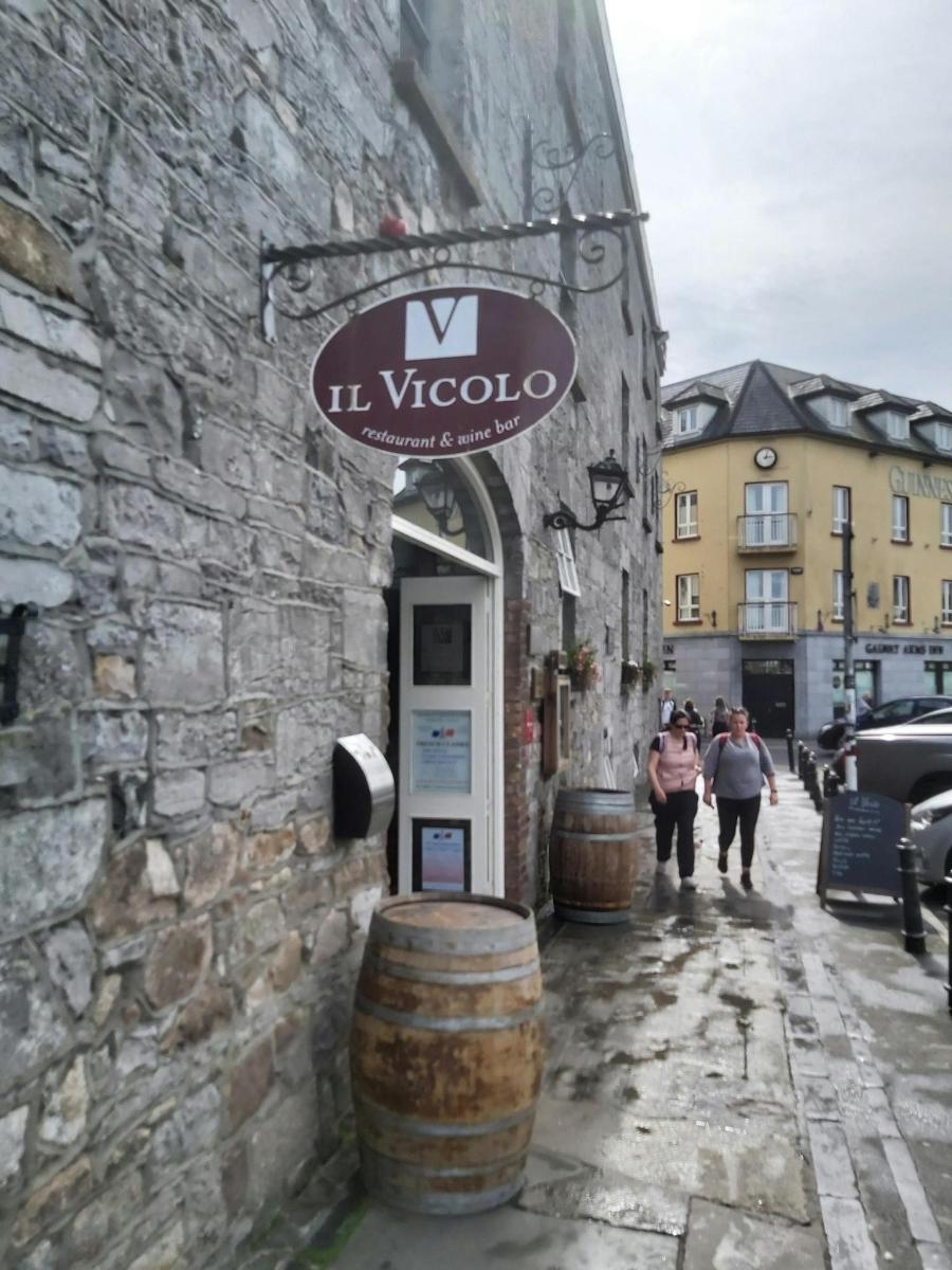a building with a sign on the side of it with barrels