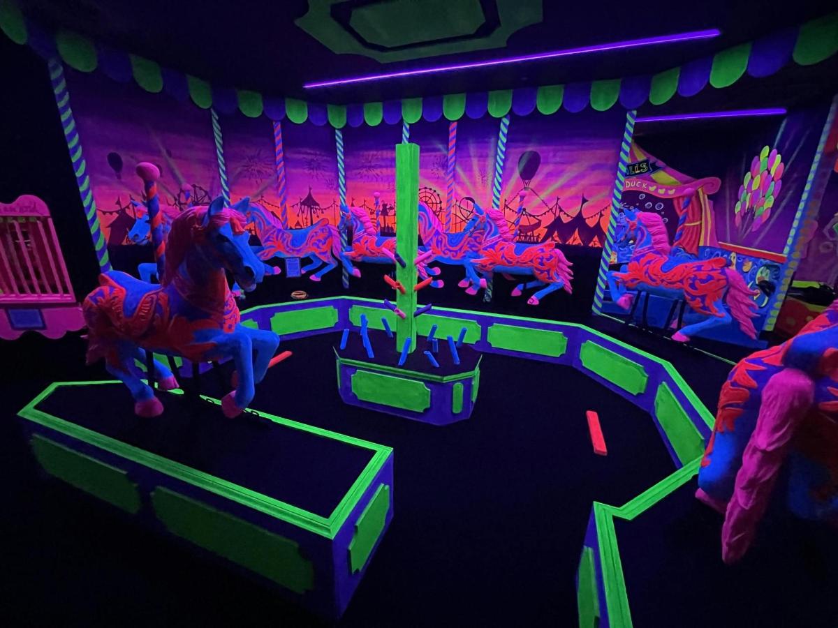 a room with a play set with horses and people
