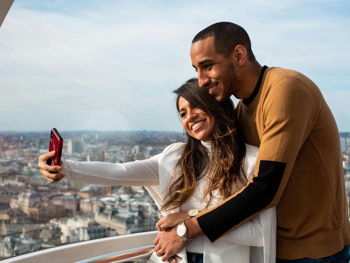 a man and a woman looking at a cell phone