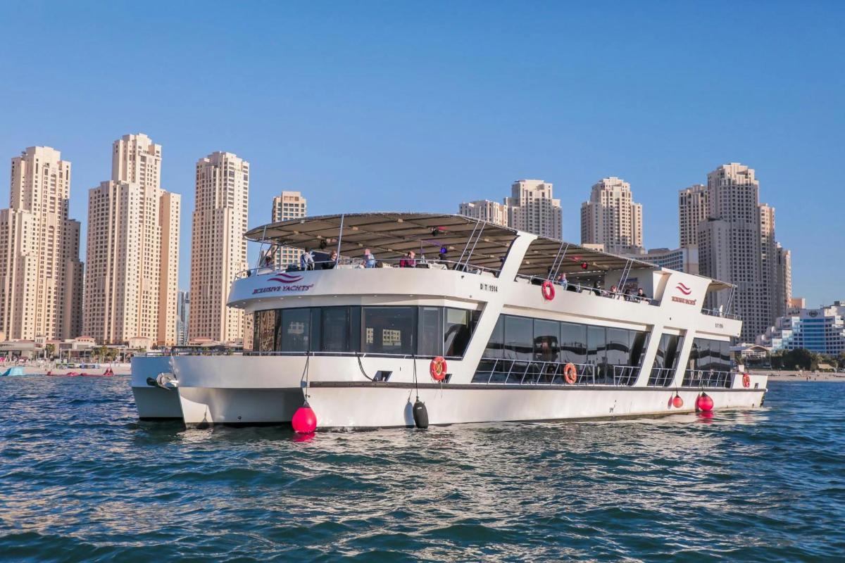 a white boat in the water with a city in the background