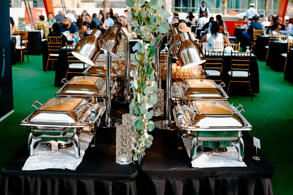 a row of silver plates on top of a table
