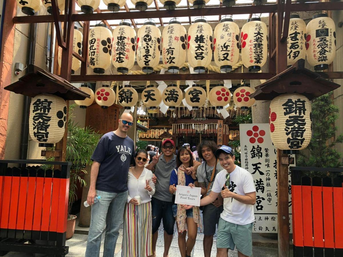 a group of people standing in front of a gate