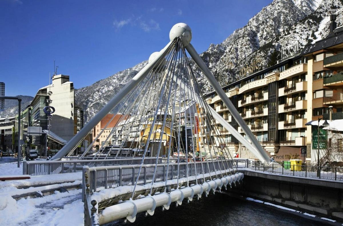 a bridge over a river in front of a building