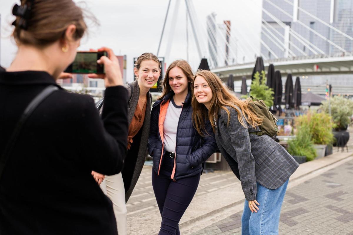 a woman taking a picture of two women
