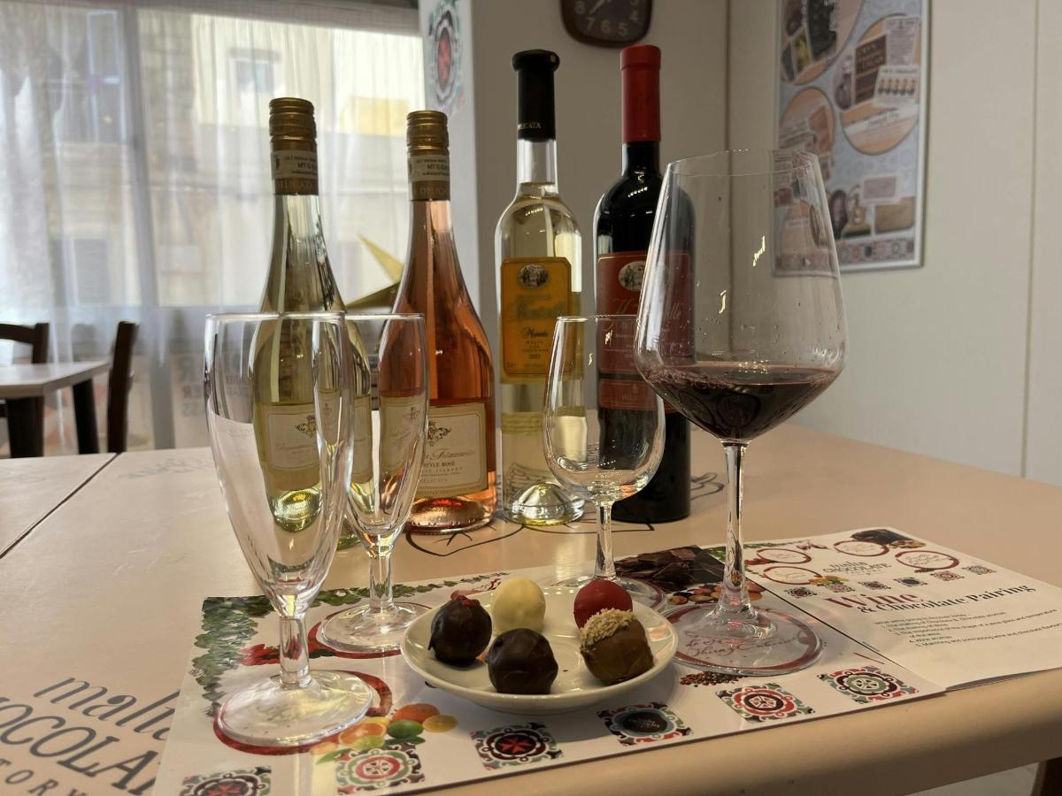 a table with wine glasses and a plate of food