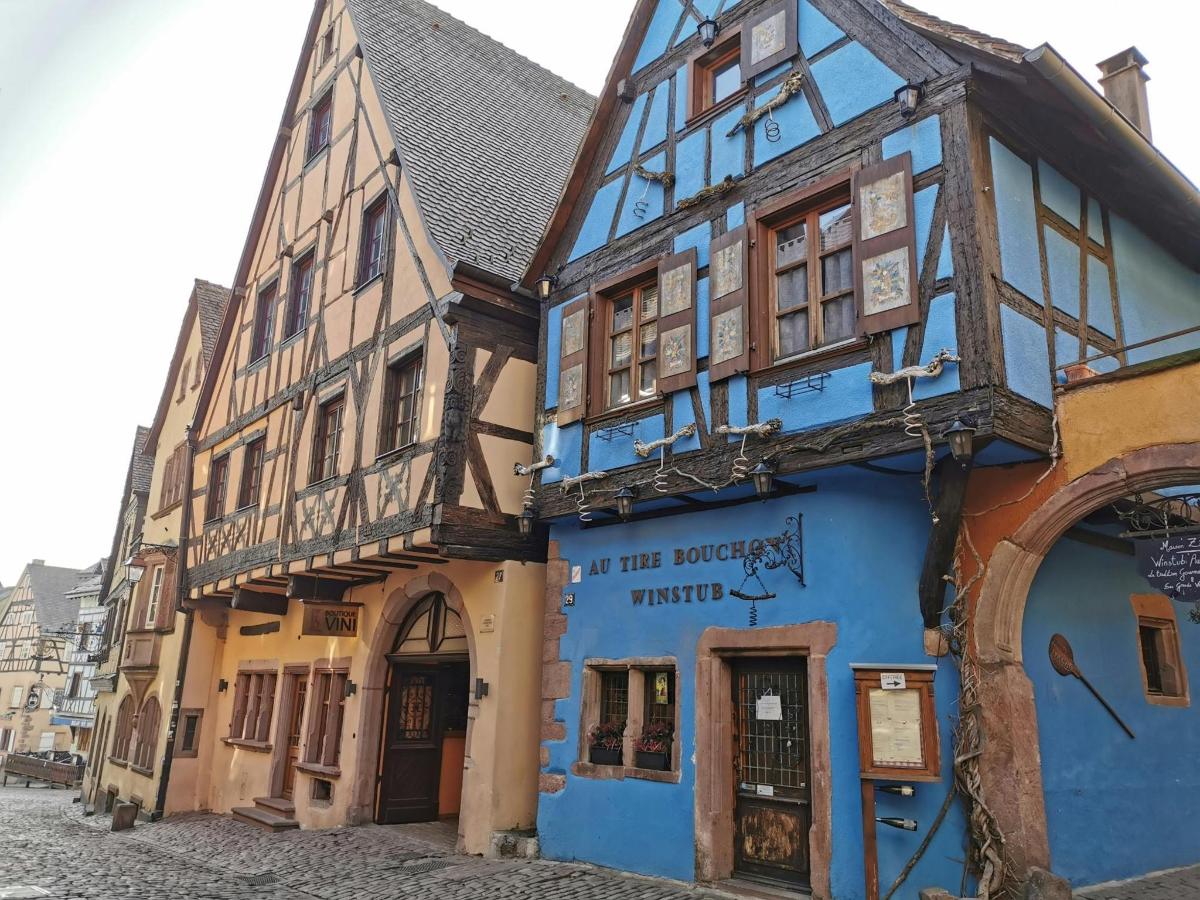 an old building with blue paint on a street