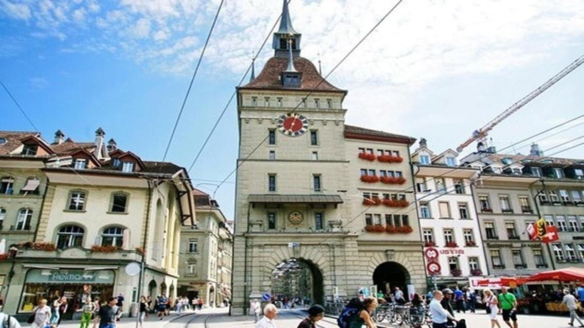 a large building with a clock tower in a city