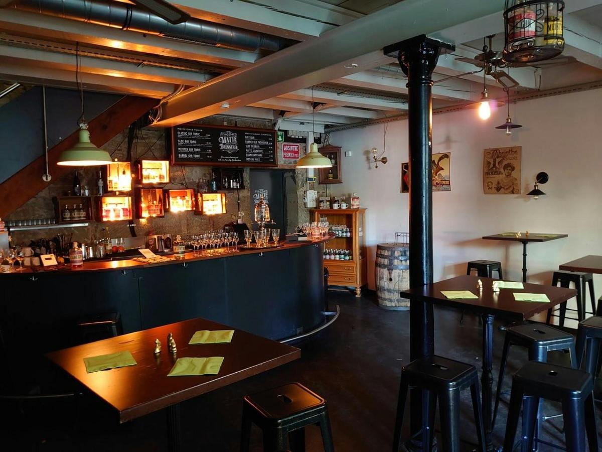 a restaurant with a bar and tables and chairs