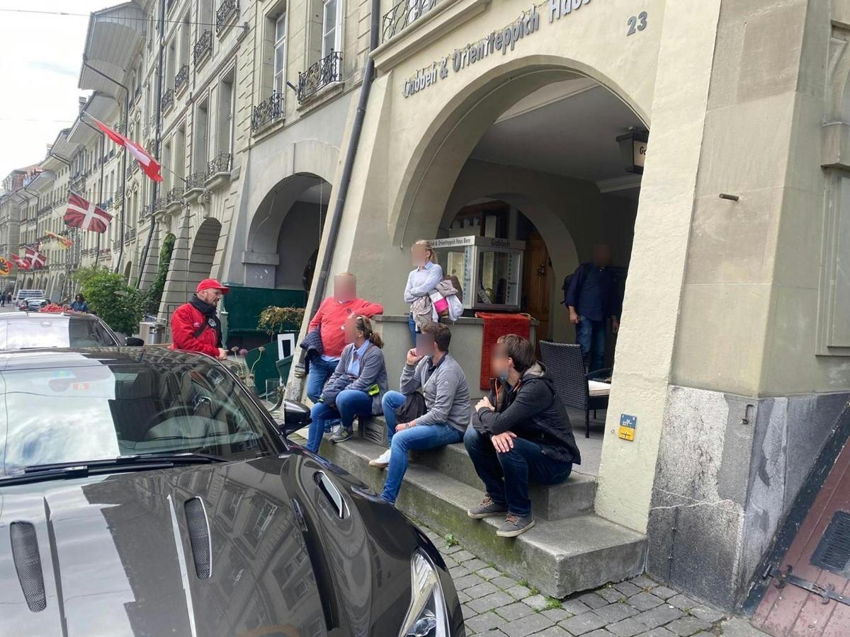 a group of people sitting outside of a building