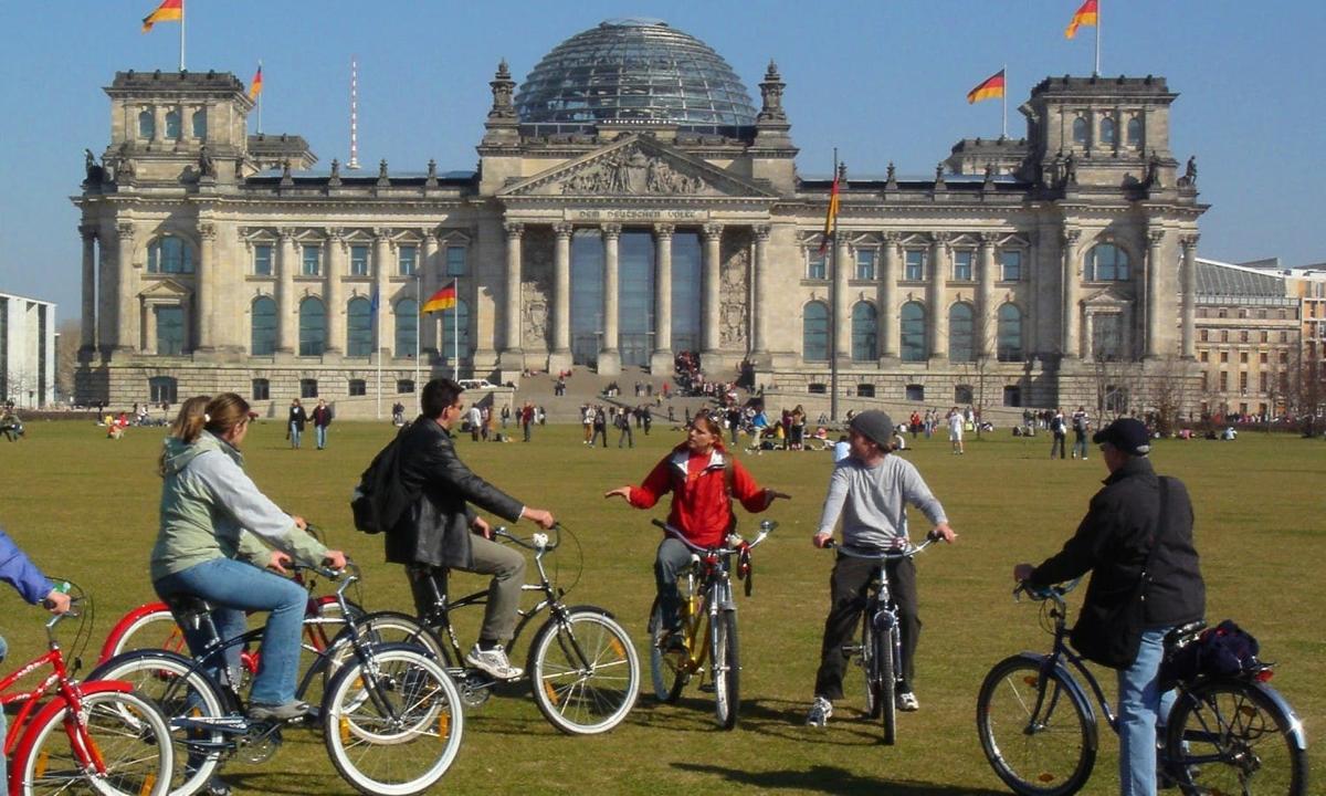 a group of people on bikes in front of a building