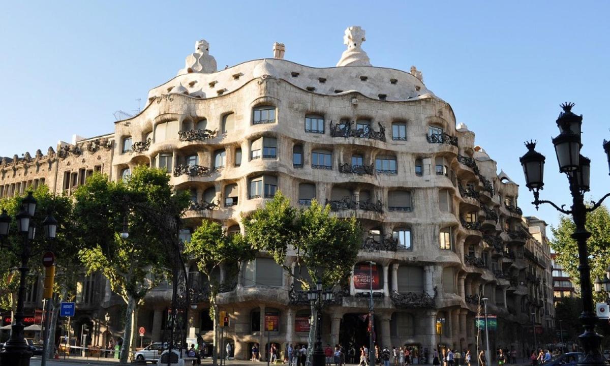 a large building on a city street with people in front