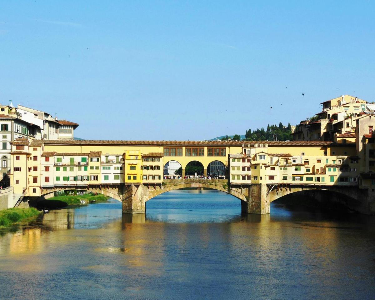a bridge over a river in a city with buildings