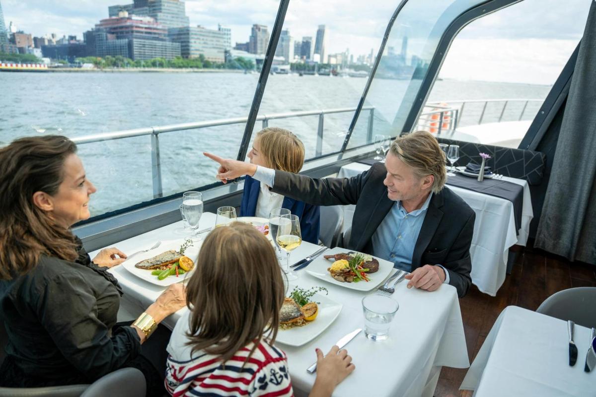a group of people sitting around a table on a boat