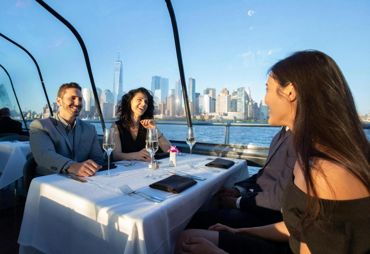 a group of people sitting around a table on a boat