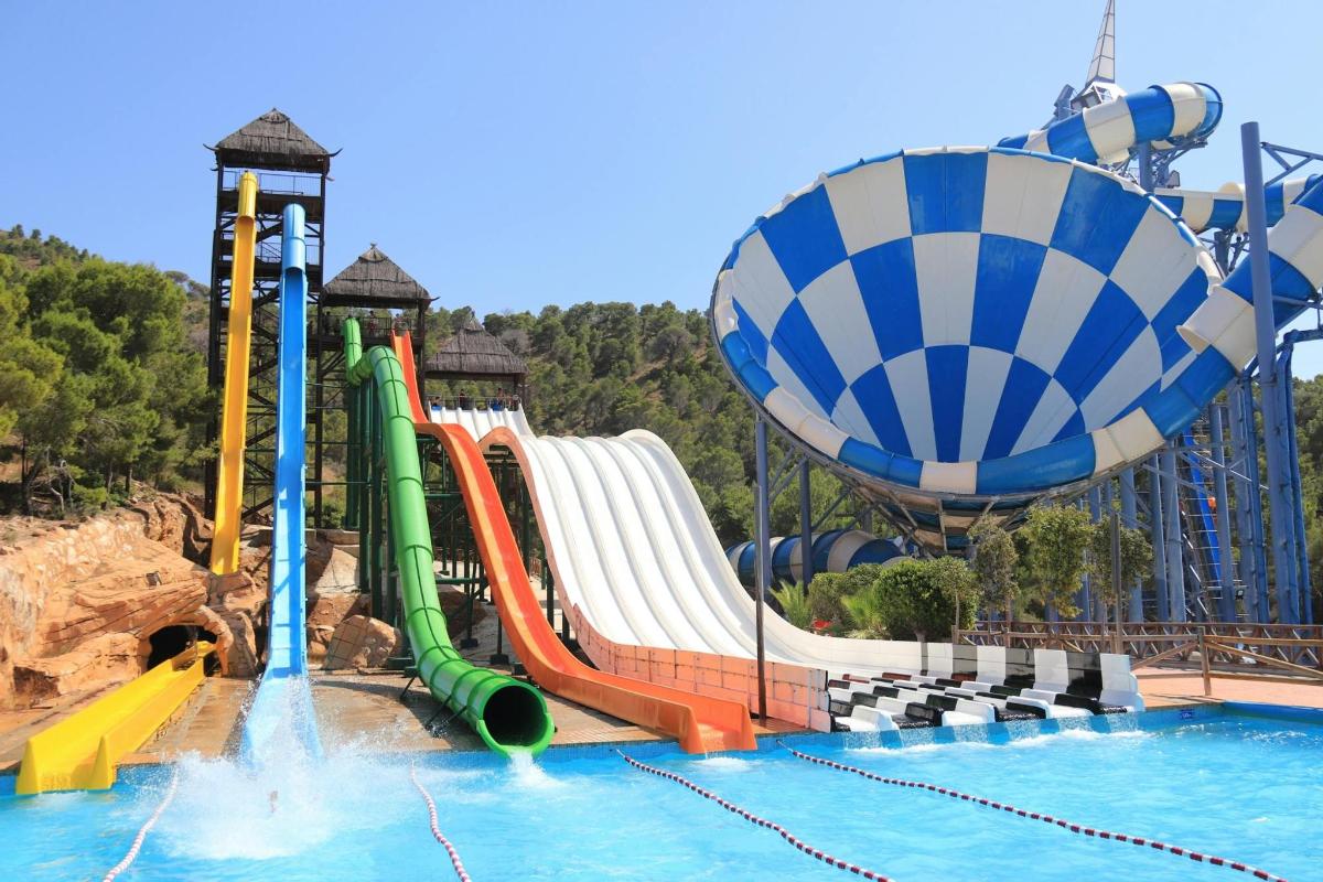 a water park with a water slide and a roller coaster