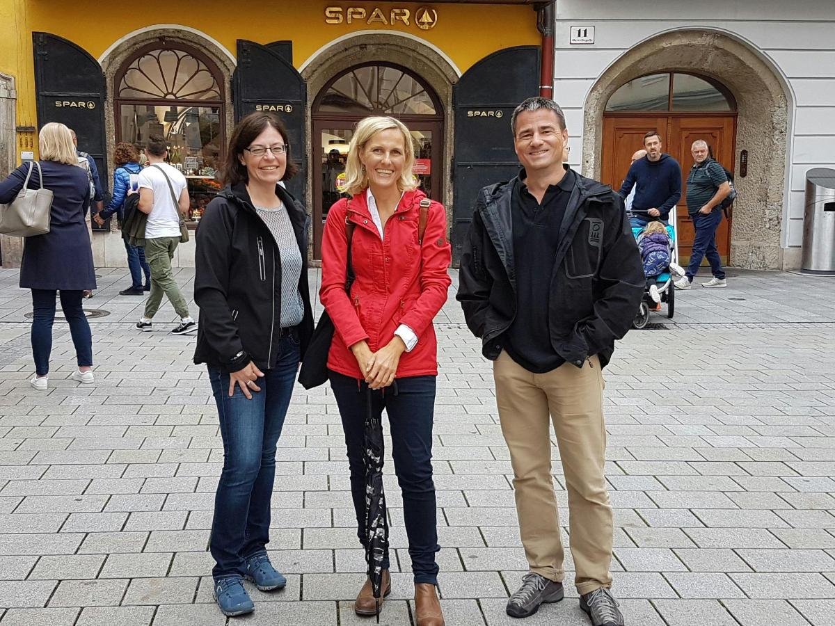 a man and two women standing in a street