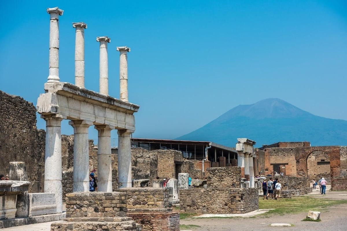 a group of ruins with a mountain in the background