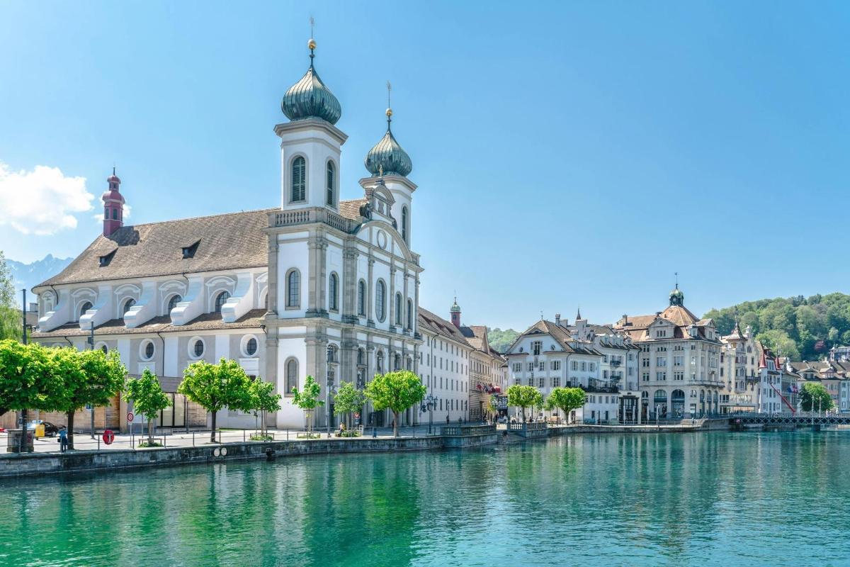 a building with a clock tower next to a river