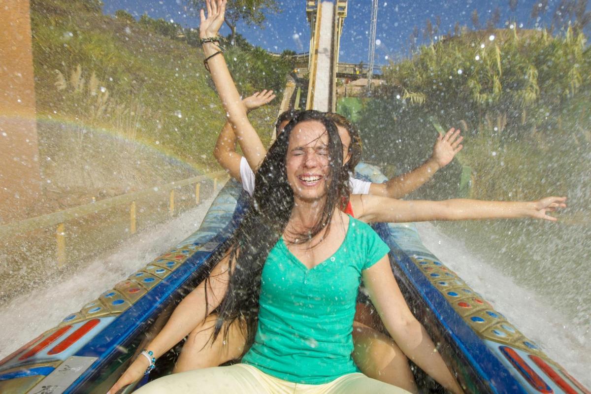 a woman riding a roller coaster in the rain
