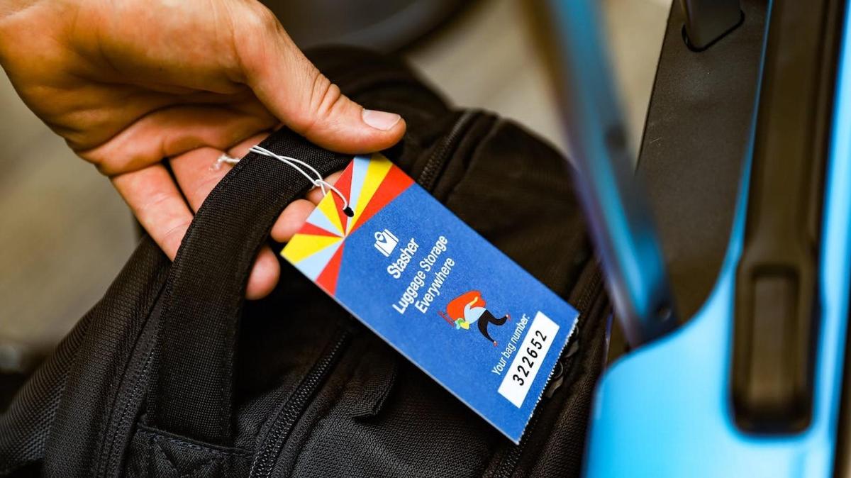 a person holding a tag on a bag