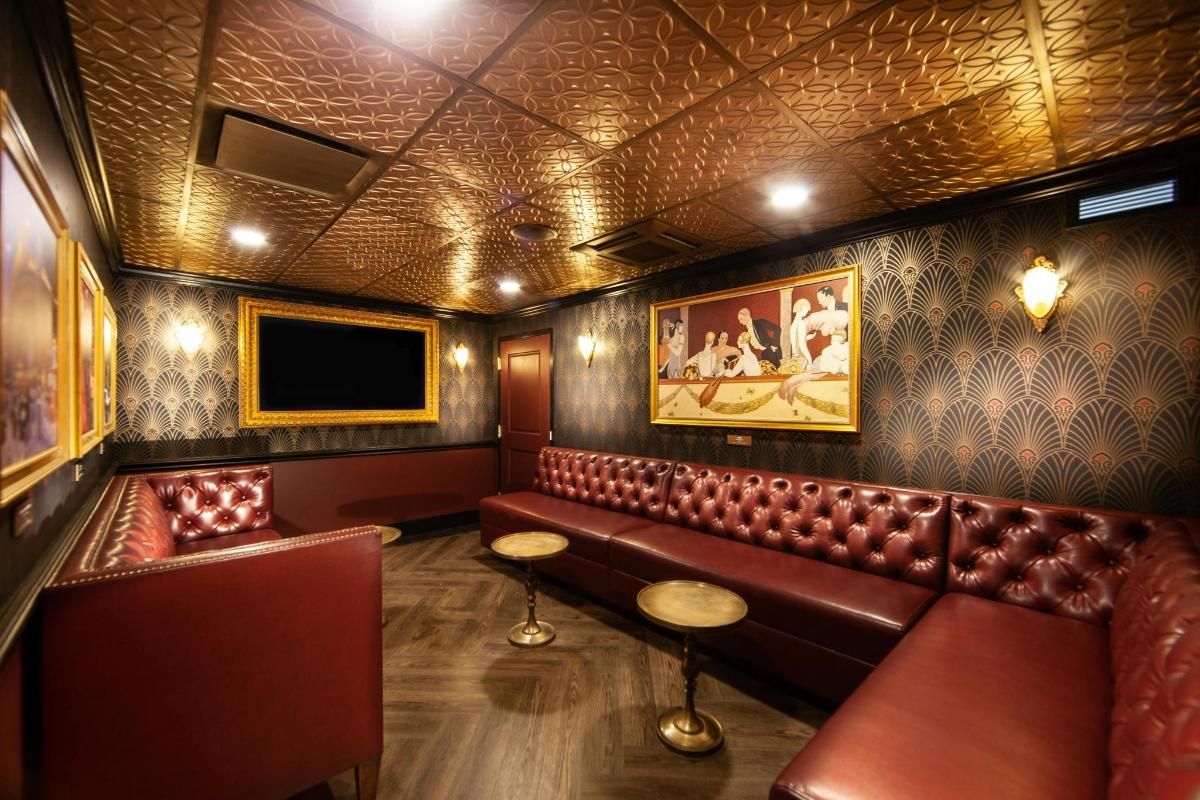 a pub with brown leather seats and a flat screen tv