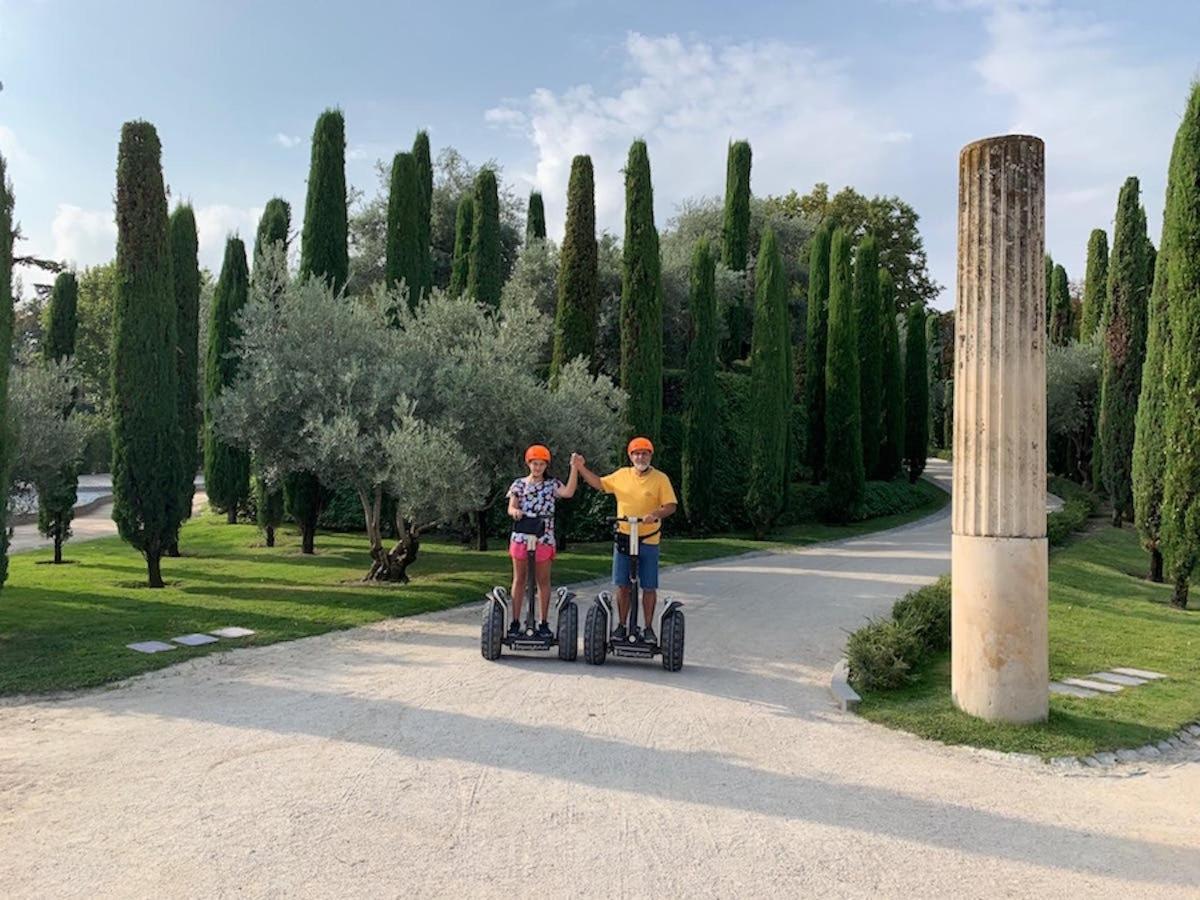 a man and a woman riding on segways in a park