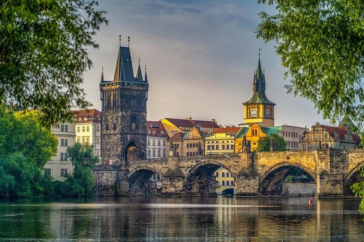 an old bridge over a river with a city