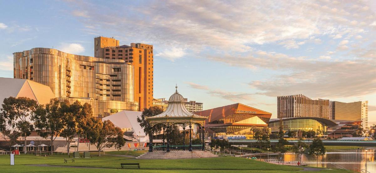 a city skyline with tall buildings and a park