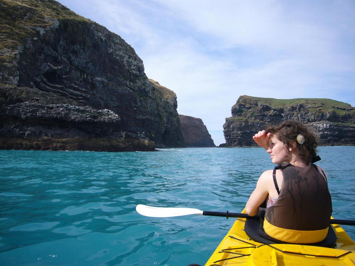 a woman paddling a kayak on the water