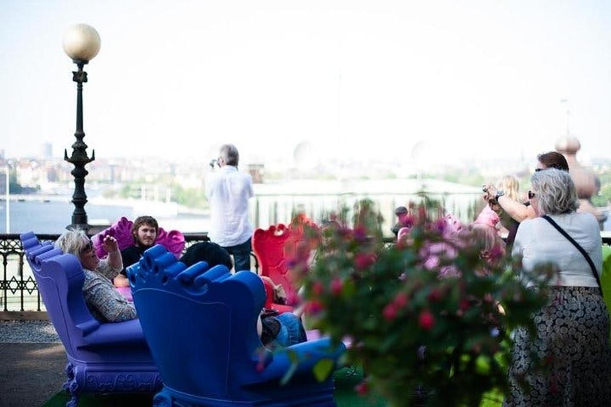a group of people sitting in chairs on a balcony