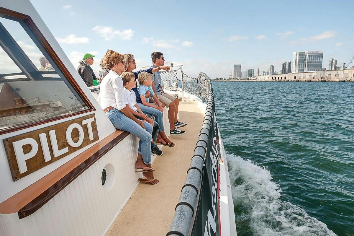 a group of people sitting on a boat in the water