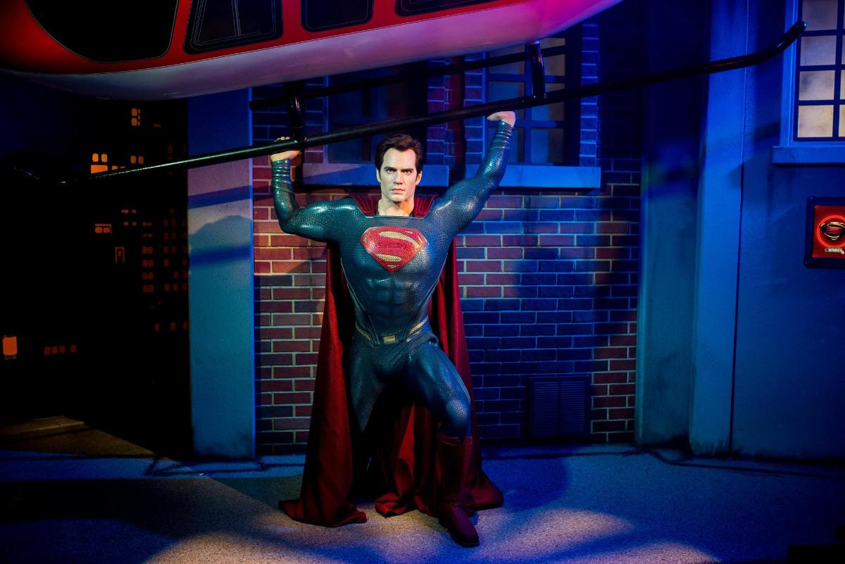 a man in a superhero costume standing in front of a building