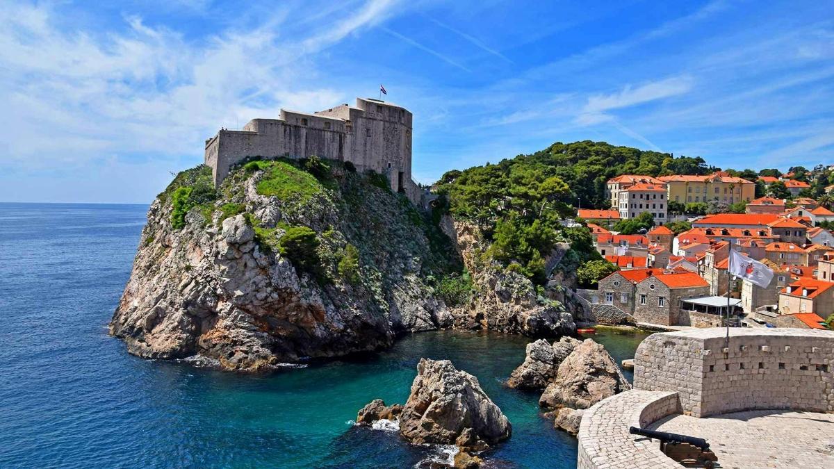 a castle on top of a rock in the ocean