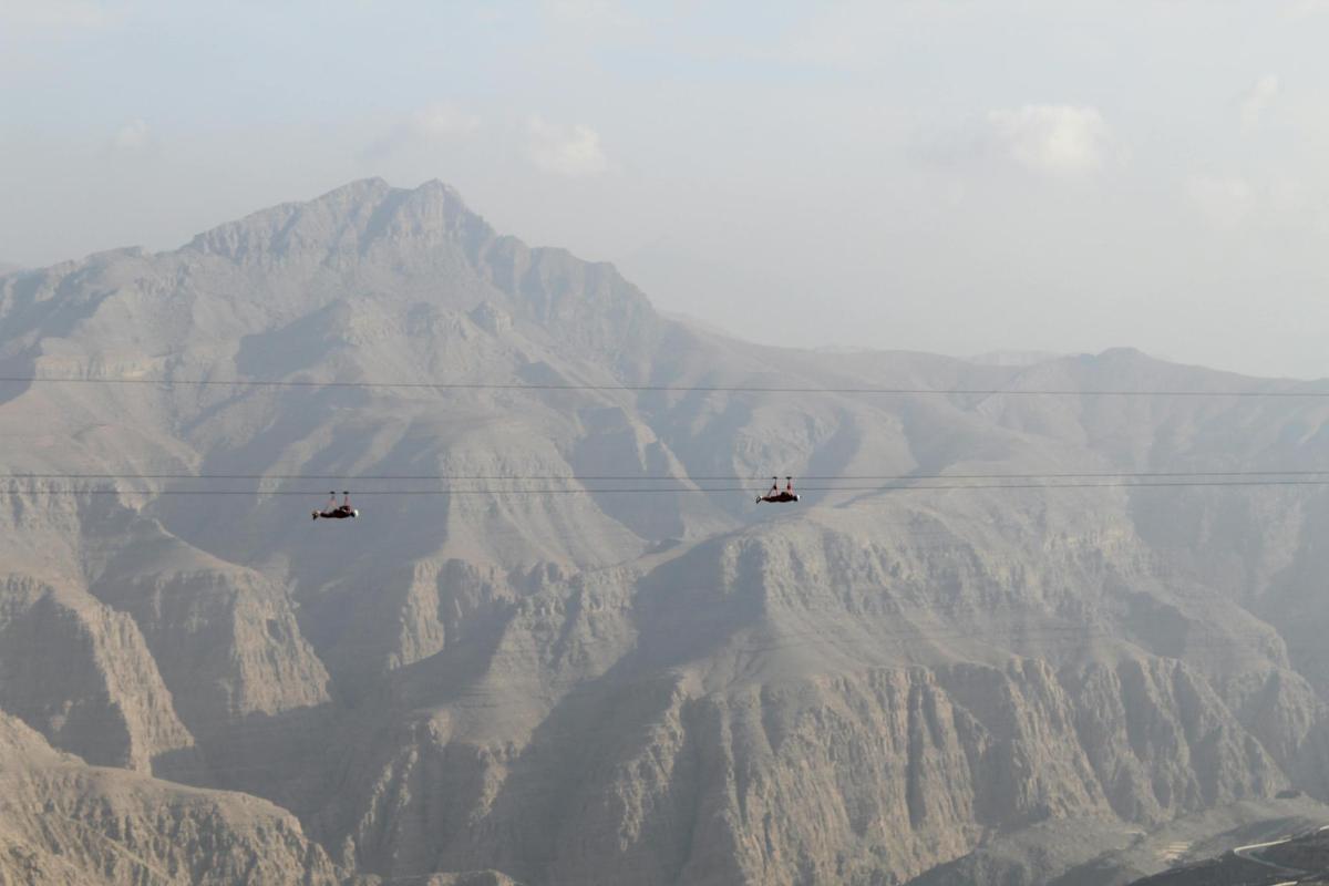 three jets flying over a mountain range in the sky