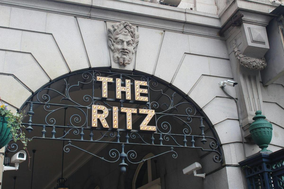 a sign on the front of a building with a statue