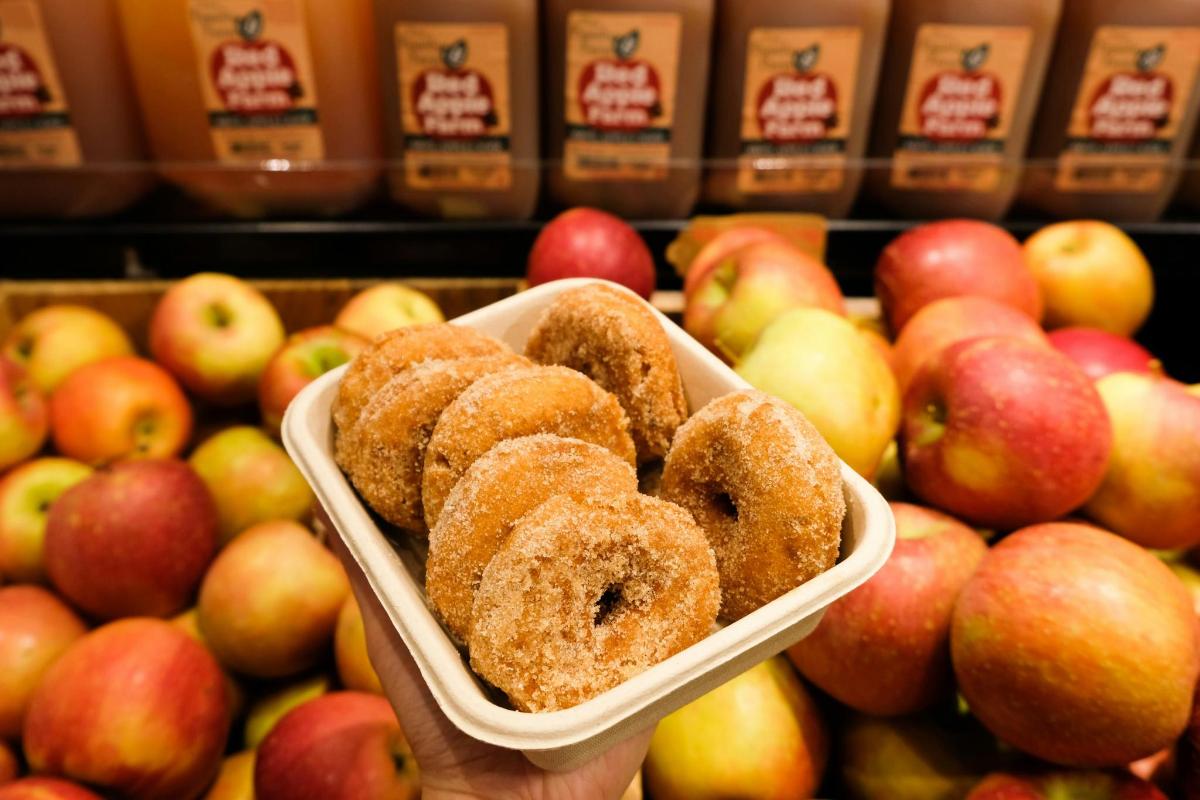 a bowl of donuts sitting on top of apples