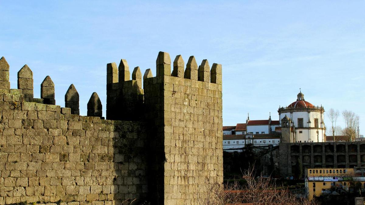 a brick wall with a building in the background