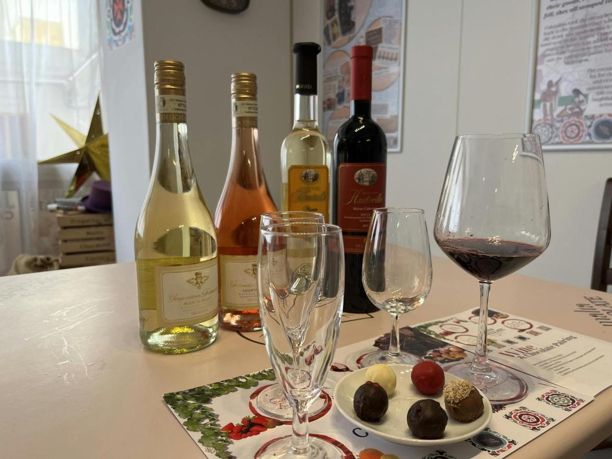 a table with two glasses and bottles of wine