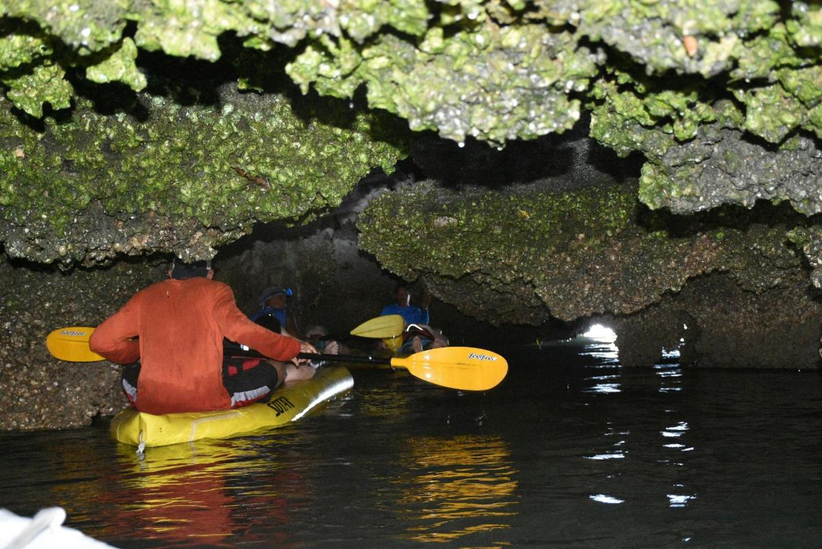 a man in a kayak in a cave