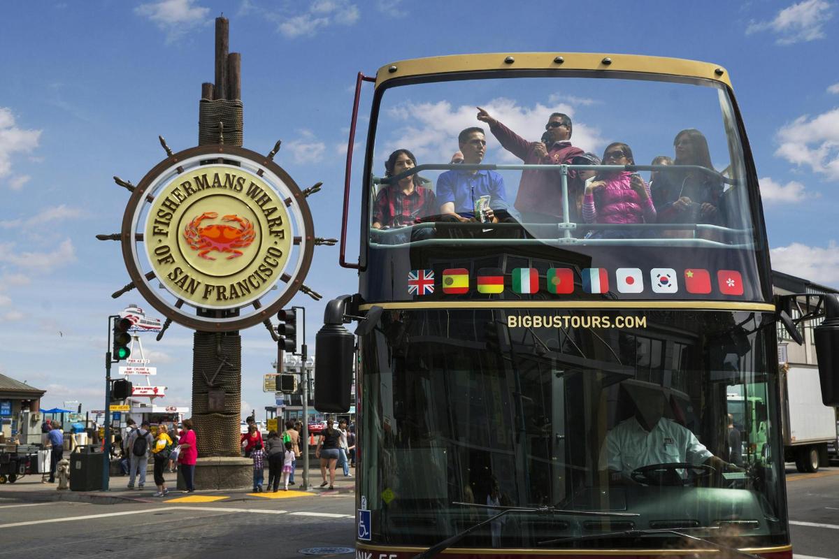 a double decker bus driving down a city street