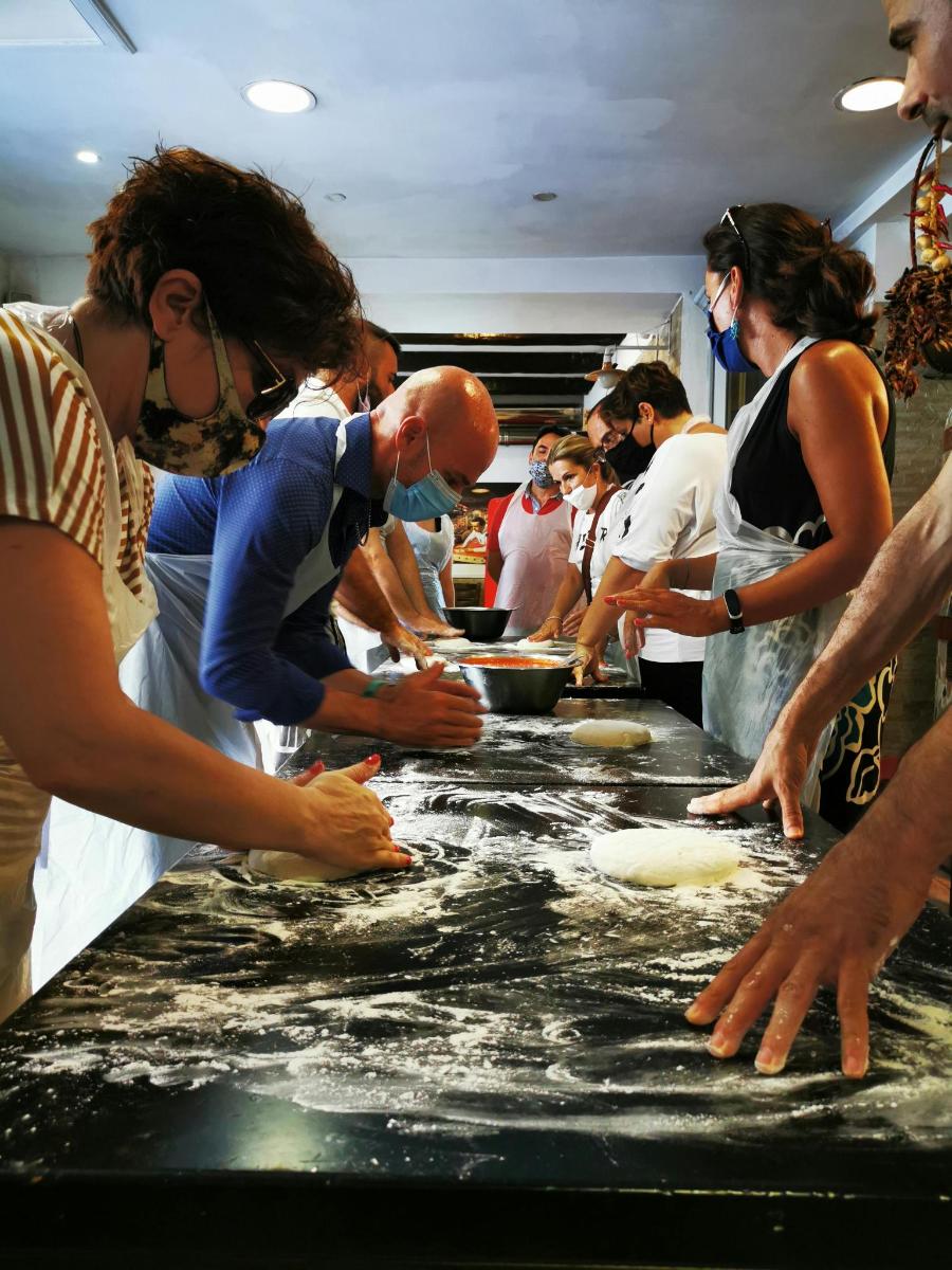 a group of people preparing food in a kitchen