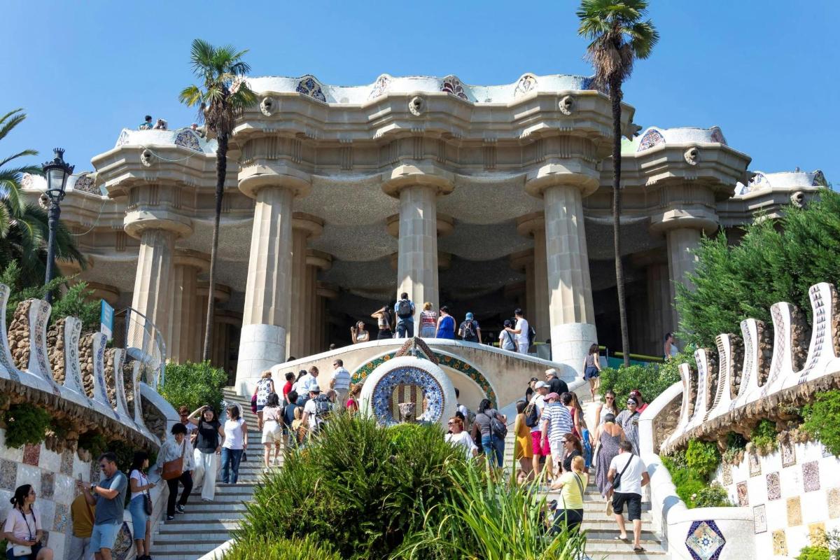 a group of people walking up stairs in front of a building
