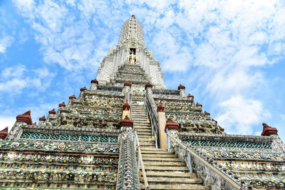 a tall building with stairs leading up to the sky