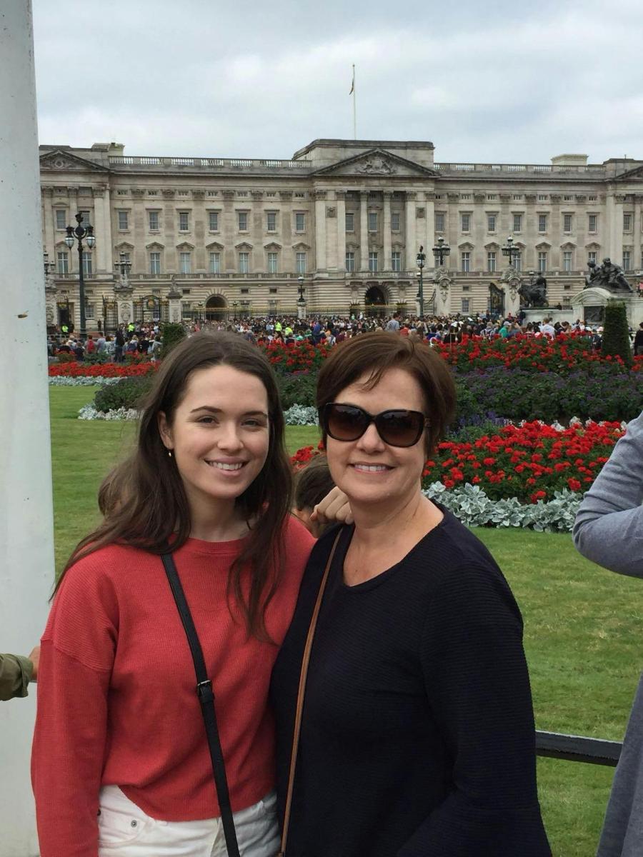 two women standing in front of a building