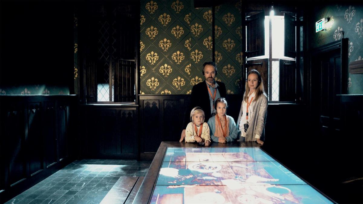 a group of people standing around a table