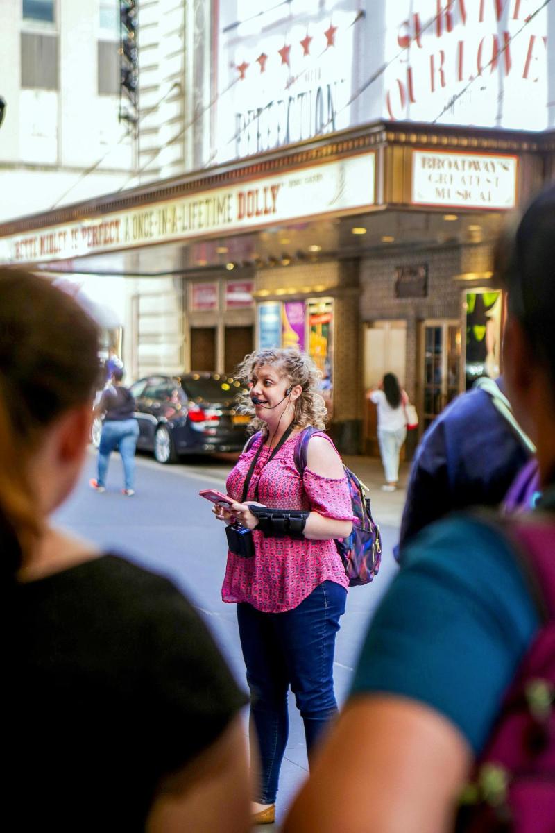 a woman walking down the street with a cell phone